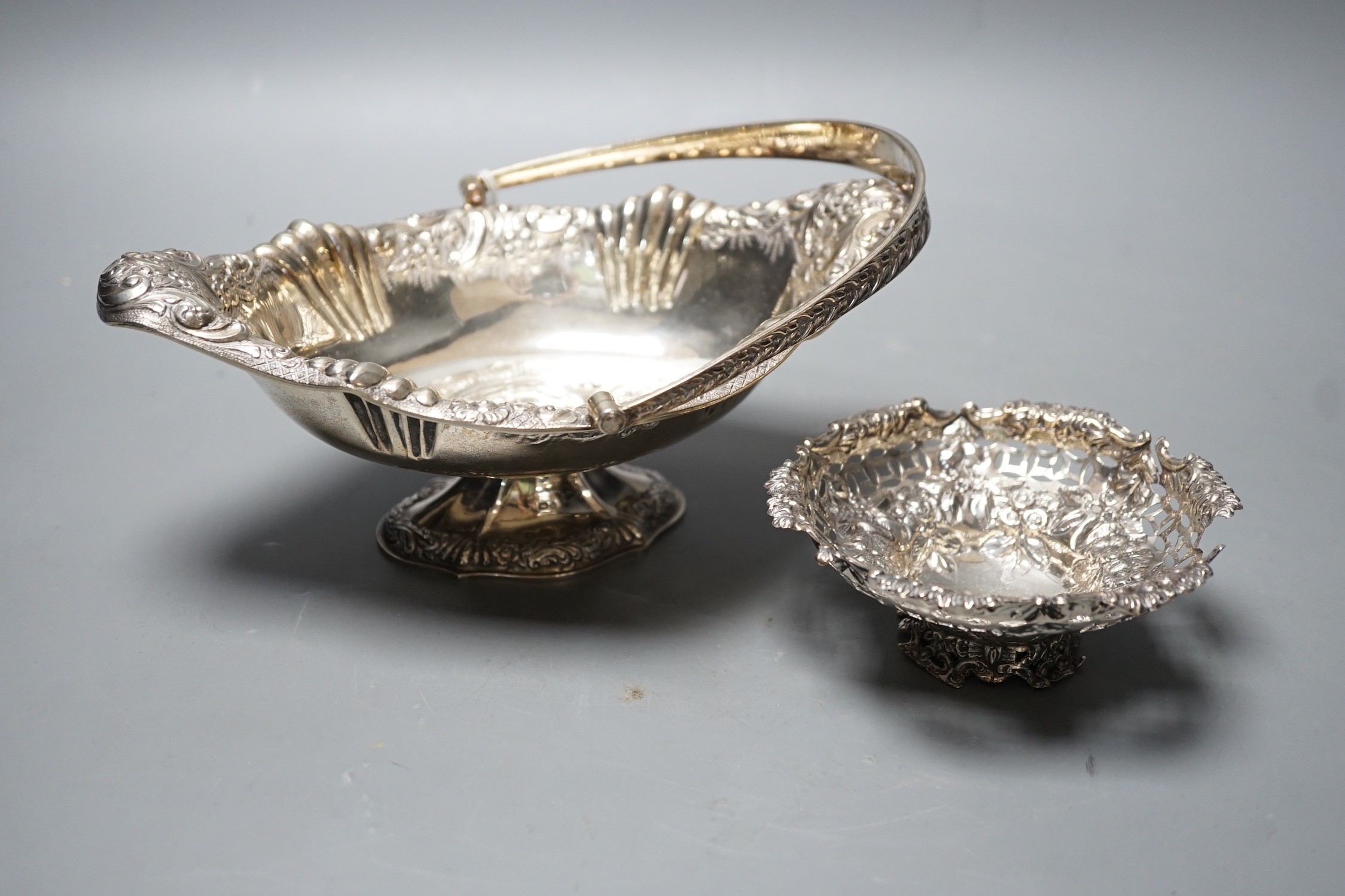 A late Victorian silver oval embossed bon bon basket , Chester, 1893, 21.4cm,and a small bon bon basket, the latter (a.f.), 11oz.